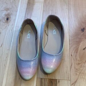 Children place sparkly multicolored shoes